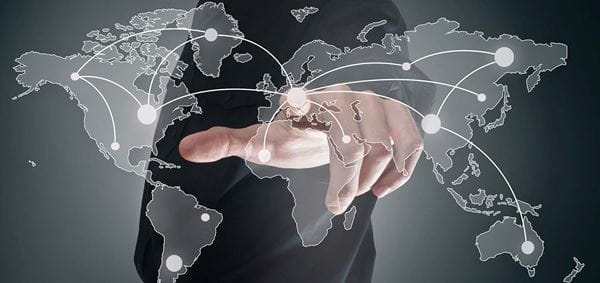 Photo of the world map overlaid on a person pointing straight ahead
